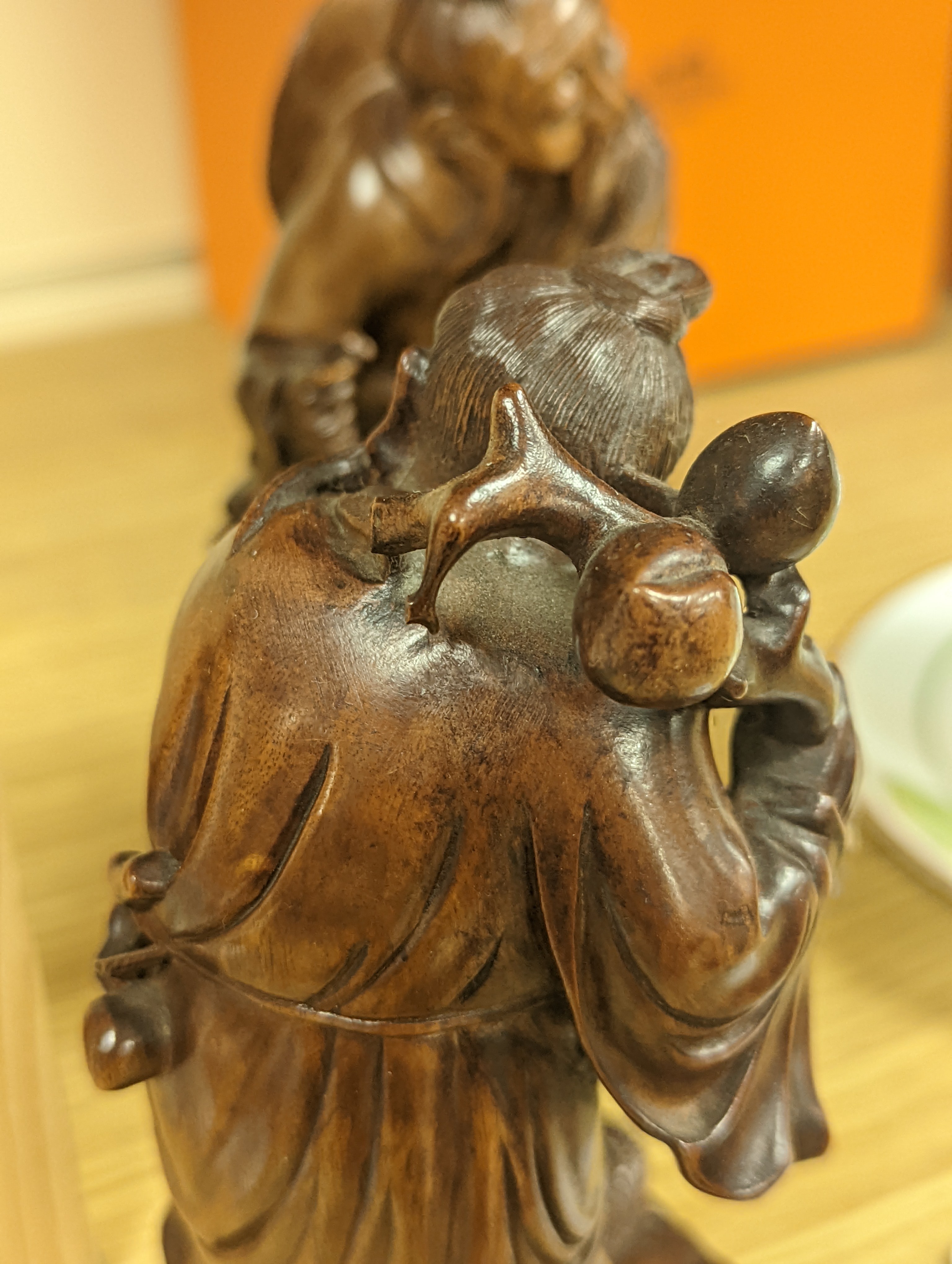 Two Chinese hardwood figures of a fisherman and a old man holding peaches 16cm